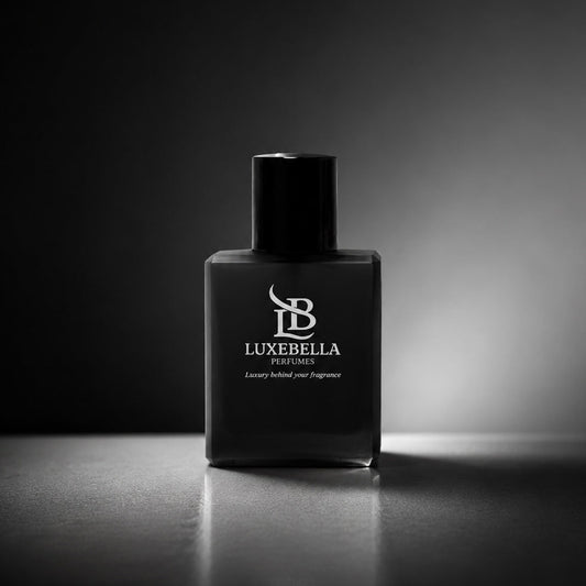 A matte black rectangular bottle of Luxebella Fragrance with a matching black cap, standing on a reflective dark surface against a black background with a spotlight effect.